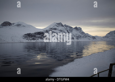 From a trip in the fjords of Greenland. Iceberg and cold water. Rocks. The Nuuk city is located in the beginning of the fjord. Stock Photo