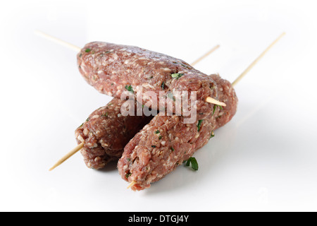 Lamb kofta skewers over a white background Stock Photo