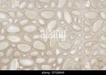 textured stone wall background with small stones and cement Stock Photo