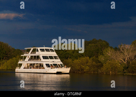 Cruise along the Victoria Falls aboard the ' African Queen'.  Other boats sailing in the Zambezi River. This is the Lady Stock Photo