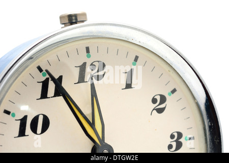 Conceptual shot of the 'five minutes to twelve hours.' Old alarm clock. Stock Photo