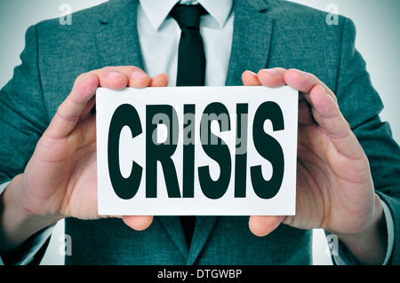 a man wearing a signboard with the word crisis written in it Stock Photo