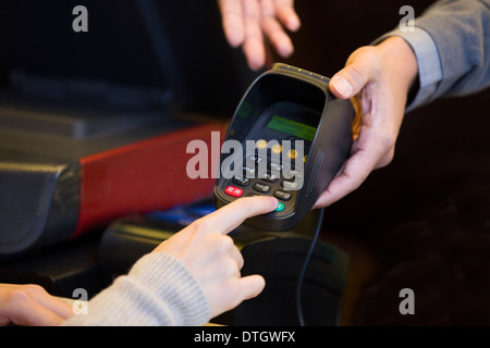 Customer entering credit card password Stock Photo