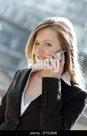 Business woman using a mobile phone, Lower Saxony, Germany Stock Photo