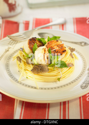 Spaghettis with scallops,truffles,basil and sprouts Stock Photo