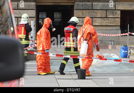 Leipzig, Germany. 18th Feb, 2014. Fire fighters in protective suits work in front of the German Federal Administrative Court in Leipzig, Germany, 18 February 2014. White powder had been discovered in a letter there which caused a red alert. The substance was taken away for analysis. Photo: SEBASTIAN WILLNOW/DPA/Alamy Live News Stock Photo