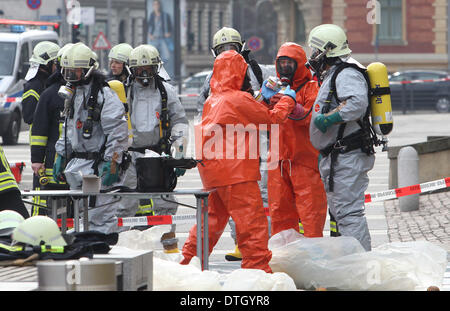 Leipzig, Germany. 18th Feb, 2014. Fire fighters in protective suits work in front of the German Federal Administrative Court in Leipzig, Germany, 18 February 2014. White powder had been discovered in a letter there which caused a red alert. The substance was taken away for analysis. Photo: SEBASTIAN WILLNOW/DPA/Alamy Live News Stock Photo