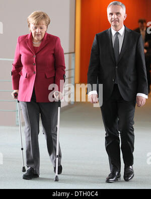 Berlin, Germany. 18th Feb, 2014. Swiss President and Foreign Minister Didier Burkhalter and German Chancellor Angela Merkel (CDU) arrive for a press conference after their meeting in Berlin, Germany, 18 February 2014. Photo: WOLFGANG KUMM/DPA/Alamy Live News Stock Photo