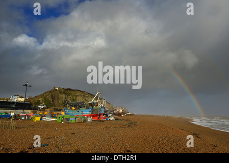 Rainbow over the Stade fishing beach. Hastings old town. East Sussex. UK Stock Photo