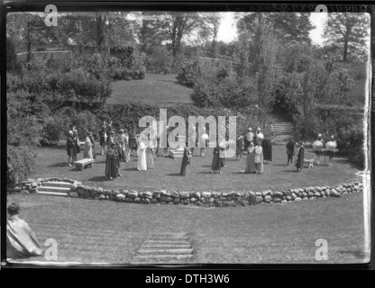 This photograph from 1927 captures students of Western College participating in Tree Day, an event focused on the celebration of nature and outdoor activities. It depicts students engaging in extracurricular activities with open-air theatrical productions, symbolizing the institution's commitment to women’s education and student involvement in community events. Stock Photo
