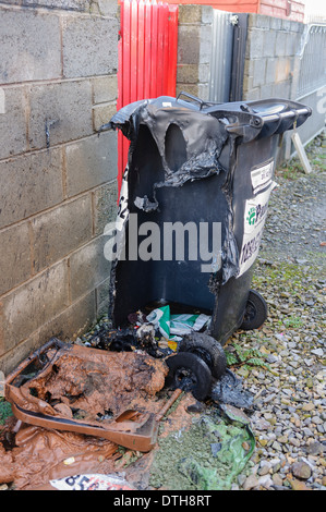 Two plastic bins melted after being set on fire. Stock Photo