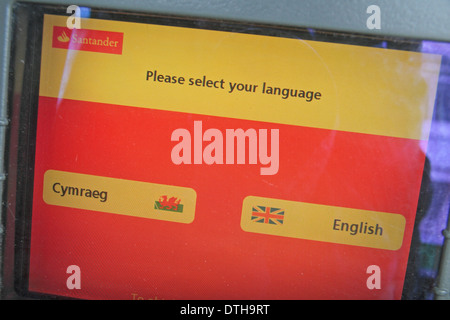 Bilingual options screen on a Santander ATM cash machine in Pembroke, Pembrokeshire, Wales. Stock Photo