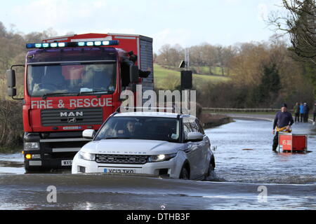 Egham, Surrey, UK. 17th February 2014. Flood Scenes From Egham, Surrey  A car negotiates floodwaters as West Yorkshire Fire And Rescue Service Set up pumps to clear the A308 Windsor Road near Runnymede. Credit:  John Maxwell-Roberts/Alamy Live News Stock Photo