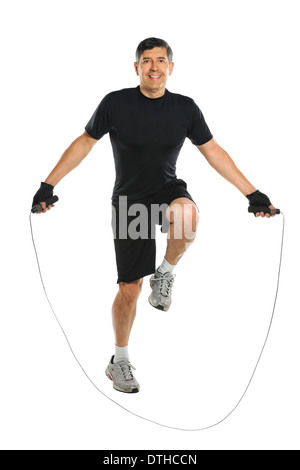 Active Hispanic senior jumping rope isolated over white background Stock Photo