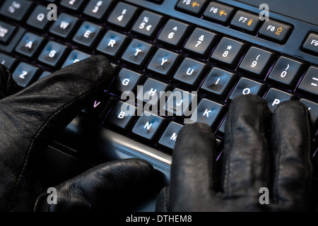Hacker using laptop. Lots of digits on the computer screen. Stock Photo