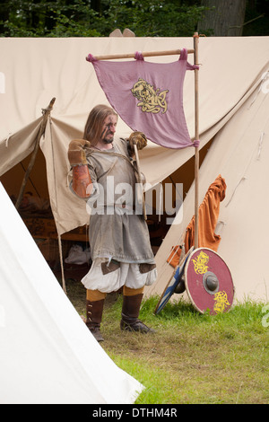 Viking warrior preparing for battle at a viking reenactment festival in Denmark Stock Photo