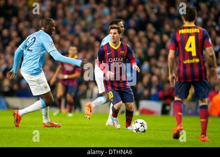 Manchester, UK. 18th Feb, 2014. FC Barcelona forward Lionel Messi challenged by Toure during the Champions League game between Manchester City and Barcelona from the Etihad Stadium. Credit:  Action Plus Sports/Alamy Live News Stock Photo