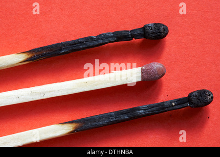 Bryant & May Extra Long Matches - used matches set against red background Stock Photo