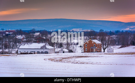 House and barn in a snow-covered farm field in Gettysburg, Pennsylvania. Stock Photo