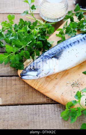 raw fish, greens on a chopping board, food Stock Photo