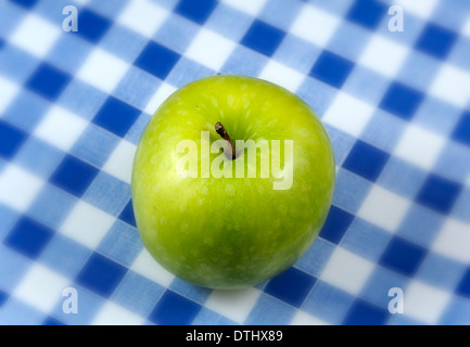 Granny Smiths apple on a blue gingham background Stock Photo