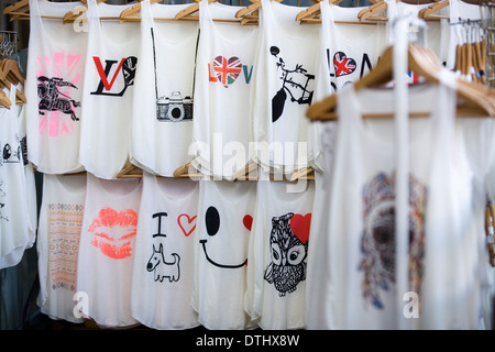 T shirts on sale on a market stall Stock Photo