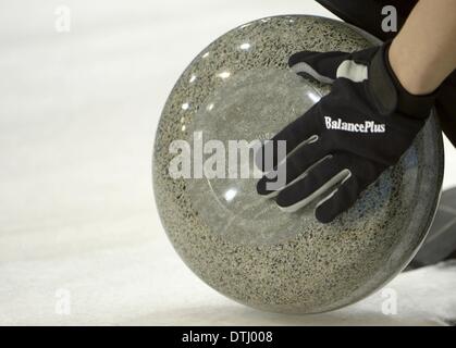 Sochi, Russia. 18th Feb, 2014. Cleaning the stone. Mens curling - GBR v CHN - Ice Cube Curling Centre - Olympic Park - Sochi - Russia - 17/02/2014 Credit:  Sport In Pictures/Alamy Live News Stock Photo