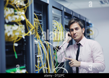 it engeneer talking by phone at network room Stock Photo