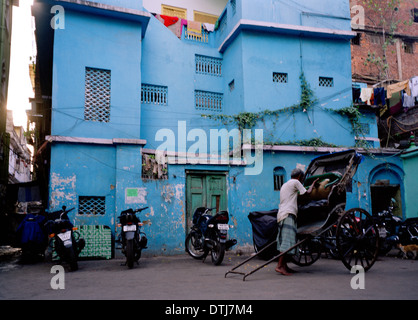 Pulled Rickshaw in the city of Kolkata Calcutta in West Bengal in India in South Asia. Cities Urban Poverty Slum People Man Life Travel Wanderlust Stock Photo