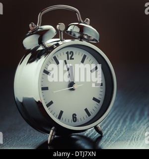 metallic Alarm clock on bedside table Stock Photo