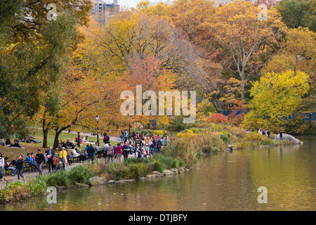 Crowds Enjoying the Fall Foliage by The Pond in Central Park,NYC Stock Photo