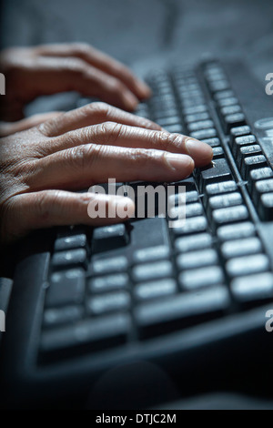 CLOSE UP OF A PERSON USING A KEYBOARD Stock Photo
