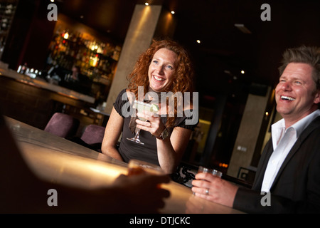 A COUPLE ENJOYING A DRINK IN A WINE BAR Stock Photo