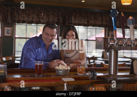 A man and woman side by side seated at a bar smiling On a date  New Hope Pennsylvania USA Stock Photo