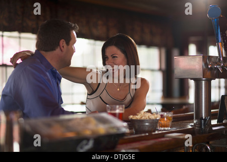 A man and woman seated at a bar flirting and talking On a date New Hope Pennsylvania USA Stock Photo
