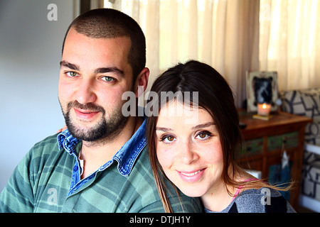 Portrait of Young Married Turkish Couple Smiling At Home Stock Photo