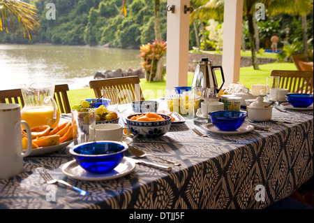 Private home in Parati Brazil. Back terrace, overlooking the sea, with the table set for breakfast. Stock Photo