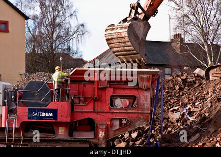 Dundee, Scotland, UK. 19th February, 2014. Safedem contractors clearing up the rubble after the demolition of two multi-storey flats along the Strathmartine Road in Dundee. Credit:  Dundee Photographics / Alamy Live News Stock Photo