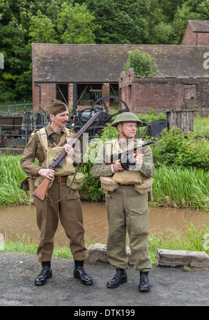 Two young adult  men dressed in second world war home guard uniform as part of 1940s reenactment. Stock Photo