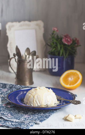 Delicious cheesecake on blue plate with fresh orange and vintage kettle Stock Photo
