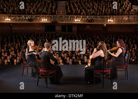 Quartet performing on stage in theater Stock Photo