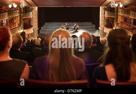 Audience watching quarter perform on stage in theater Stock Photo