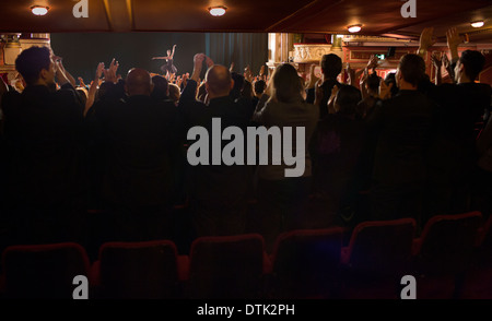 Audience watching ballerina on stage in theater Stock Photo