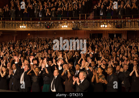 Audience cheering in theater Stock Photo