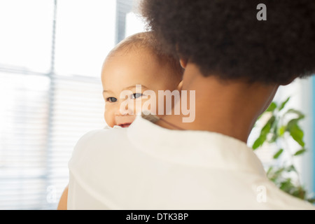 Mother carrying baby boy Stock Photo