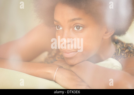 Woman resting chin in hands Stock Photo