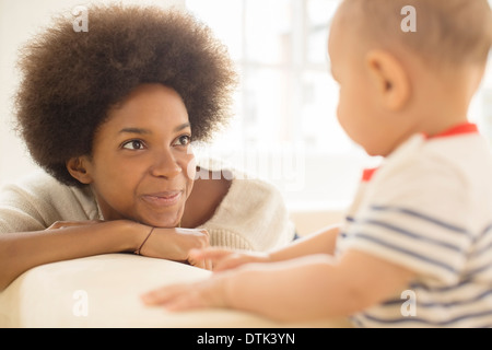 Mother and baby boy playing on sofa Stock Photo