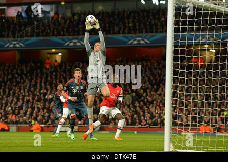 London, UK. 19th Feb, 2014. Arsenal's Wojciech Szczesny makes a save during the UEFA Champions League match between Arsenal from England and Bayern Munich from Germany played at The Emirates Stadium, on February 19, 2014 in London, England. Credit:  Mitchell Gunn/ESPA/Alamy Live News Stock Photo