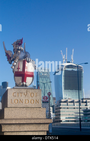City of London dragon statue and crest with changing skyline behind with 'Cheese Grater' and 'Walkie Talkie' skyscrapers London Stock Photo