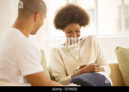 Couple relaxing together on sofa Stock Photo